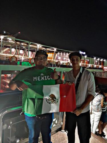 two men holding a mexican flag in front of a bus at Explore Stars Pyramids View in Cairo