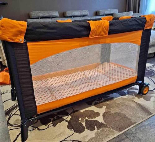 an orange and black bed in a room at Saunaga korter Tapa kesklinnas! in Tapa