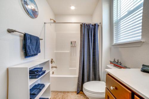 a bathroom with a toilet and a shower at WWII Aviation-Themed Apt in Sparks Near Parks! in Sparks