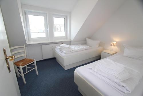 מיטה או מיטות בחדר ב-Nordseeblick II - Dünenstr 21, App 6