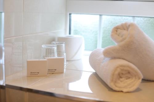 a bathroom counter with towels on a table at Killeen House Hotel in Killarney