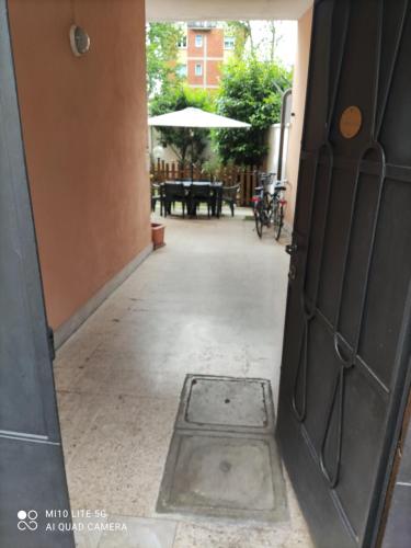 an open door to a patio with a table at HOSTAL D'ANNUNZIO HOUSe in Cesano Boscone