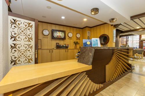 a reception desk in a room with clocks on the wall at Bursa Grand Family HOTEL in Bursa