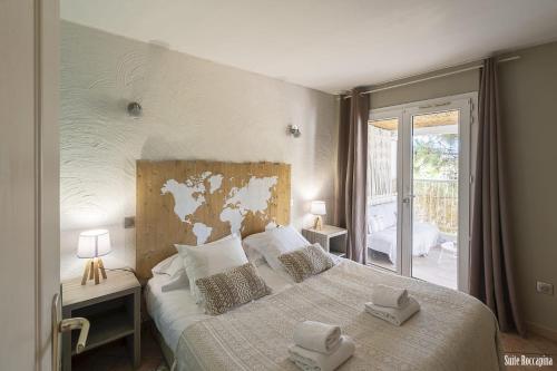 a bedroom with a large bed with towels on it at Résidence CasaBianca Porticcio - Roccapina in Porticcio