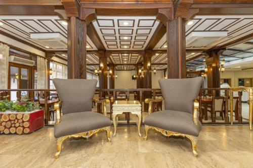 a restaurant with two chairs and a table at Bursa Grand Family HOTEL in Bursa