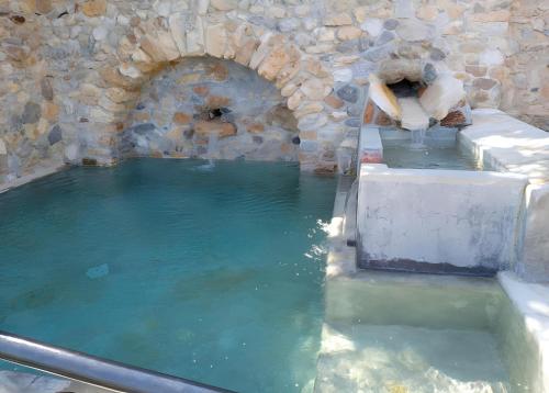 a large pool of water in a stone building at Agriturismo Bricco in Finale Ligure