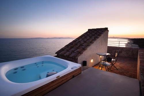 une baignoire jacuzzi sur le balcon d'une maison dans l'établissement Relais Torre Mozza - Dimora d' Epoca, à Follonica