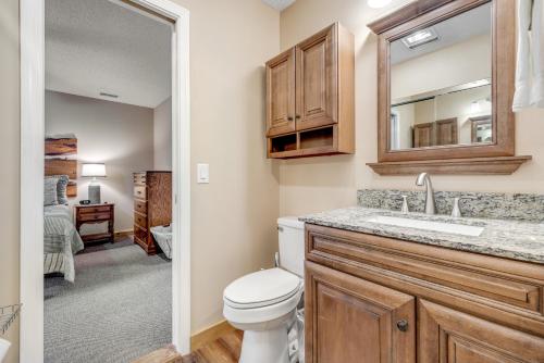 a bathroom with a toilet and a sink at Cozy Cabin in Sugar Mountain