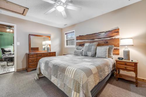 a bedroom with a large bed with a wooden headboard at Cozy Cabin in Sugar Mountain