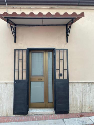 an entrance to a building with a wooden door at Herdonia Home in Ordona