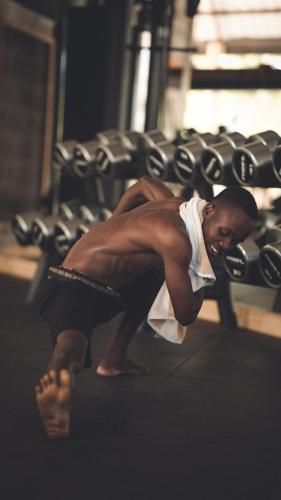a man inront of a bench in a gym at Temple Point Resort in Watamu