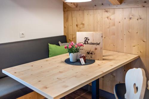 a table with a box and flowers on it at Krämerhof Apt Villnösser Geisler in Rodengo