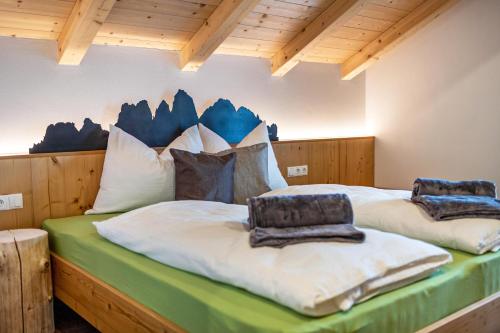 a bedroom with two beds with pillows on them at Krämerhof Apt Villnösser Geisler in Rodengo