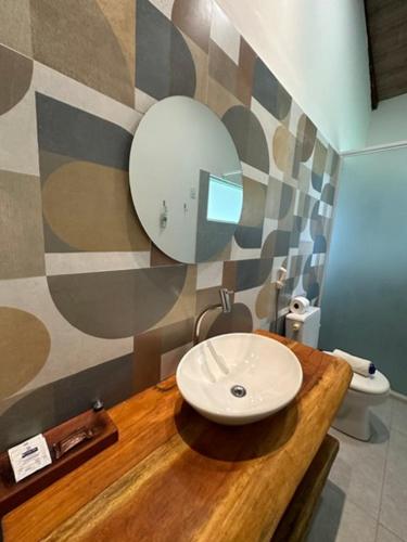 a bathroom with a sink and a mirror at Angá Beach Hotel in São Miguel dos Milagres