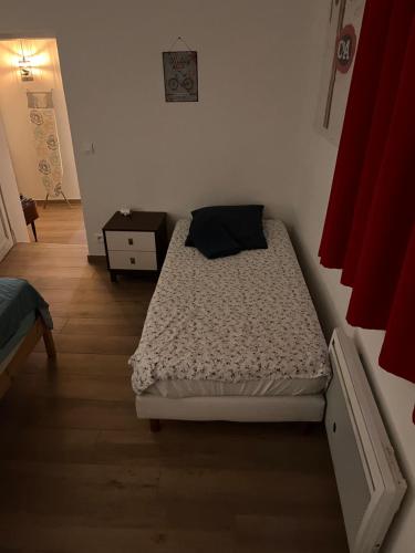 ein kleines Schlafzimmer mit einem Bett und einem Tisch in der Unterkunft Kamer met kitchenette in Bédoin
