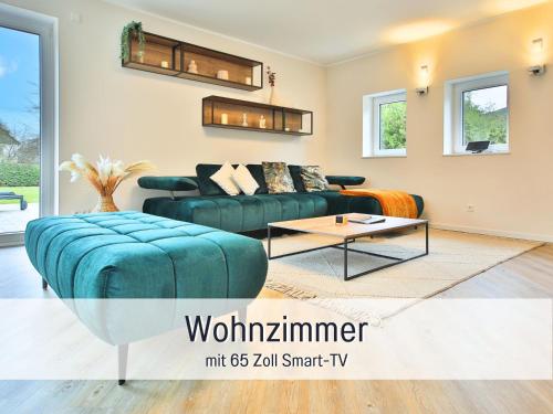 a living room with a couch and a table at Villa Heimat am Nationalpark in Allenbach
