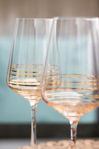 two glasses of white wine sitting on a table at Special EiNSTEiN I Apartment Basel, Messe Kleinbasel 10-STAR in Basel