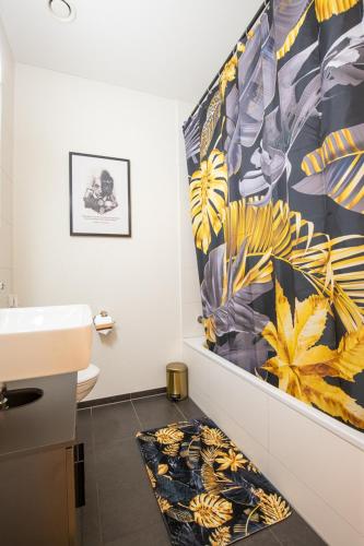 a bathroom with a sink and a towel on the floor at Special EiNSTEiN I Apartment Basel, Messe Kleinbasel 10-STAR in Basel
