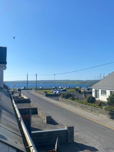 a view of a street with cars parked on the road at Lahinch Central 3-Bed Retreat in Lahinch