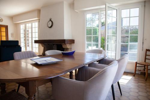 a dining room with a wooden table and chairs at Villa Topaze La Baule les Pins in La Baule