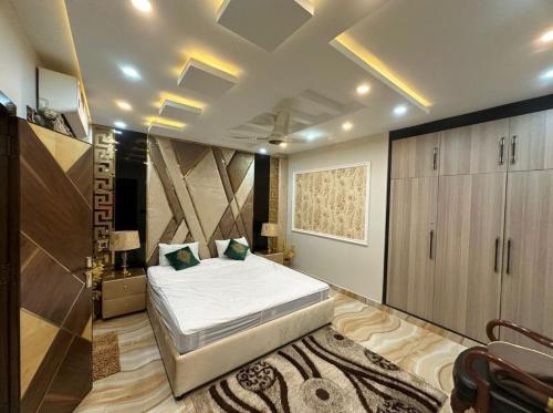 a bedroom with a large bed in a room at Luxury Penthouse Bahria Town in Lahore
