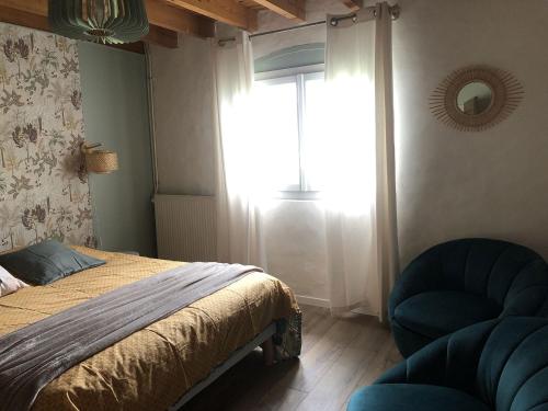 a bedroom with a bed and a window and a chair at La Bastilac chambre Nature in Garganvillar