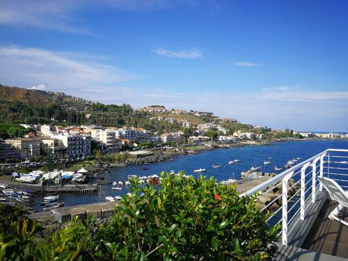a view of a harbor with boats in the water at The sea you can feel in Aci Castello