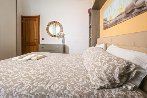a bedroom with a bed and a mirror at Il Cavalluccio Marino in Pontecagnano