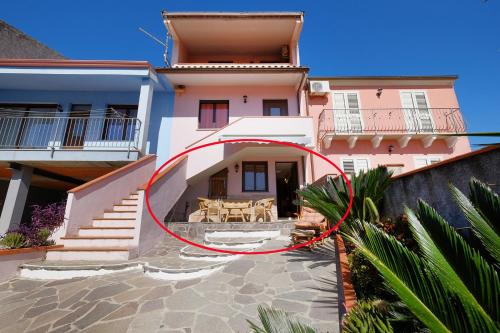 a house with a red circle in front of it at Vacanze Mare Teulada in Teulada