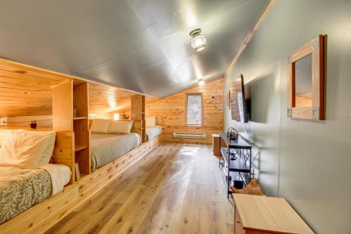 a bedroom in a log cabin with two beds at Family Cabin with Private Dock on Caribou Lake! in Lutsen