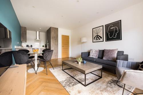 a living room with a couch and a table at Charles Hope Staines Riverside in Staines