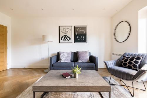 a living room with a couch and a coffee table at Charles Hope Staines Riverside in Staines