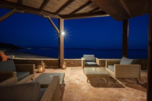 a patio with a view of the ocean at night at Torre Mozza - Dimora d' Epoca in Follonica