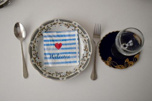 a plate with a napkin with a red heart on it at Ksamil Sea&Lake view Escape in Ksamil