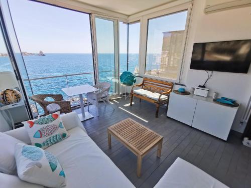 a living room with a view of the ocean at The sea you can feel in Aci Castello