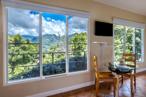 a room with a table and a window with a view at Coffee Estate Inn in Boquete