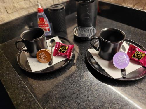 two coffee cups on plates on a kitchen counter at Apartamento no Morumbi com Piscina PRIVATIVA Aquecida e com cromoterapia, BANHEIRA DE hidromassagem, 2 vagas de GARAGEM! Alto Padrão no Morumbi ideal para quem gosta de CONFORTO E PRIVACIDADE! aptpubmorumbiinstagran in Sao Paulo