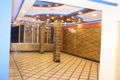a lobby of a building with a tile floor at Kashmir Inn Hotel in Muzaffarabad