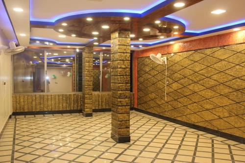 a lobby with a shower in a room with tiles at Kashmir Inn Hotel in Muzaffarabad