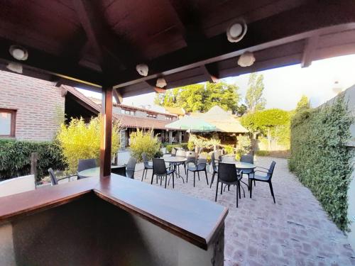 a patio with tables and chairs on a patio at Curahue Apart Hotel in Tandil