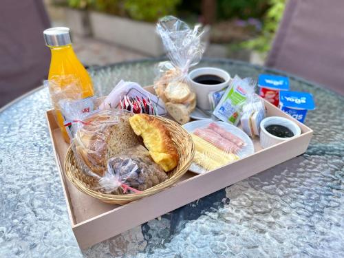 a tray of food on a table with a basket of food at Curahue Apart Hotel in Tandil