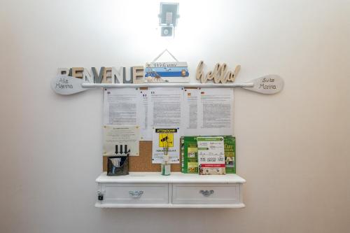 a white shelf with a sign on a wall at Alla Marina Cagliari in Cagliari