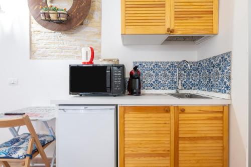 a kitchen with a microwave and a sink at Alla Marina Cagliari in Cagliari