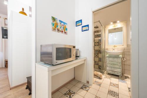 a kitchen with a microwave on a counter with a sink at Alla Marina Cagliari in Cagliari