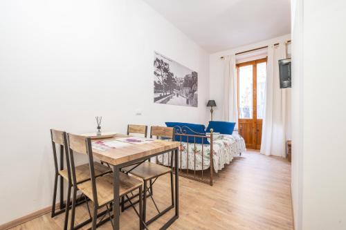 a living room with a table and a bed at Alla Marina Cagliari in Cagliari