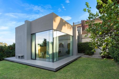 a house with a large window in a yard at Zash Country Boutique hotel & SPA in Giarre