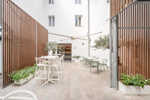 a patio with tables and chairs in a building at On The Rock in Arco