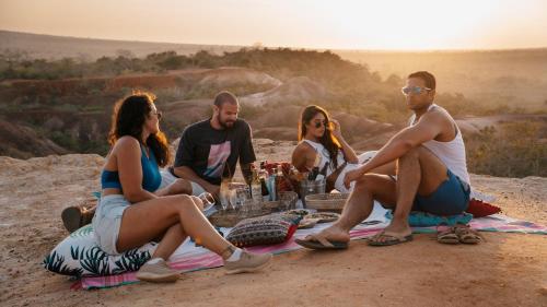a group of people sitting around a picnic blanket at Temple Point Resort in Watamu