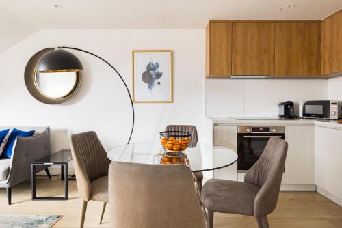 a dining room with a glass table and chairs at Charles Hope Staines Centre in Staines