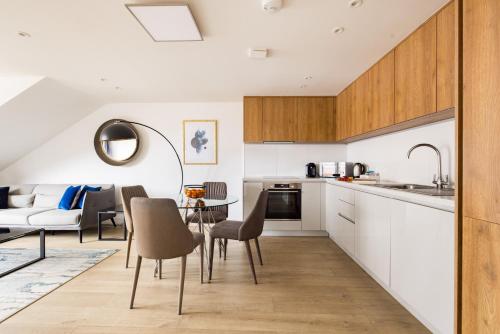a kitchen and living room with a table and chairs at Charles Hope Staines Centre in Staines